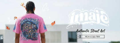 Person wearing a pink t-shirt with a colorful design, standing in front of a building with 'maje' branding.