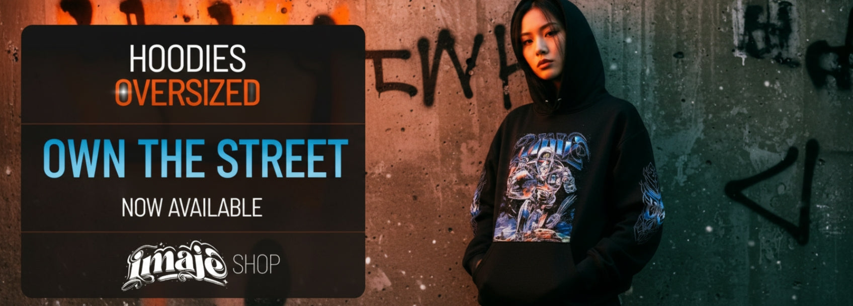 Person wearing a hoodie with text 'Hoodies Oversized' and 'Own the Street' on a graffiti-covered wall.
